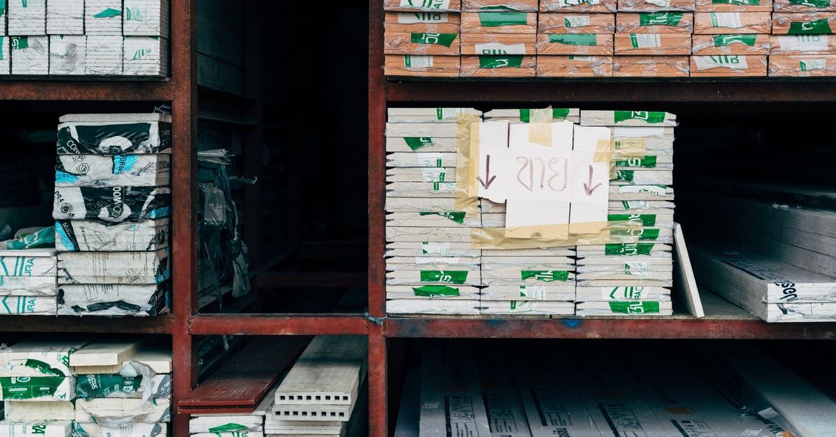 Image of a warehouse showcasing organized stacks of building materials on shelves.