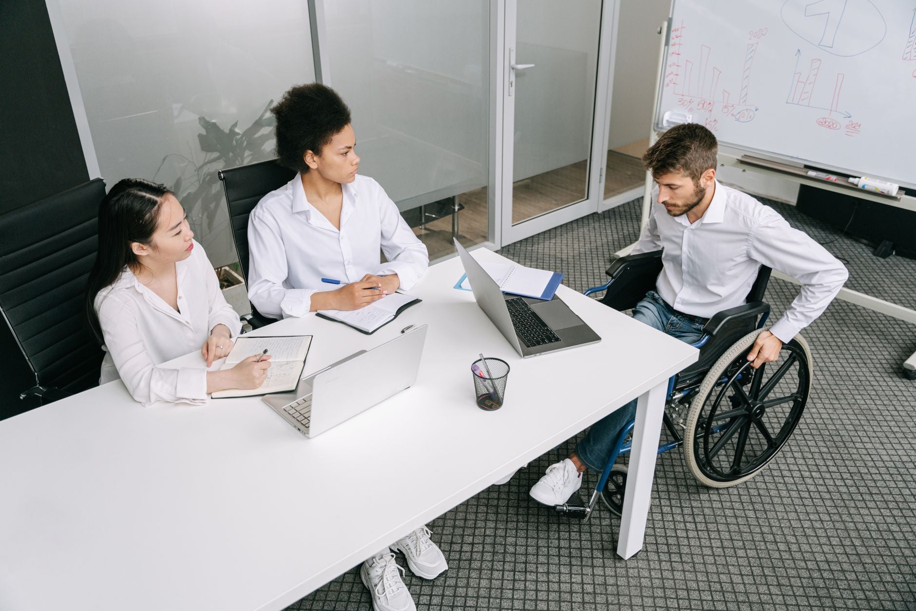 A diverse group of colleagues in a business meeting discussing ideas indoors.