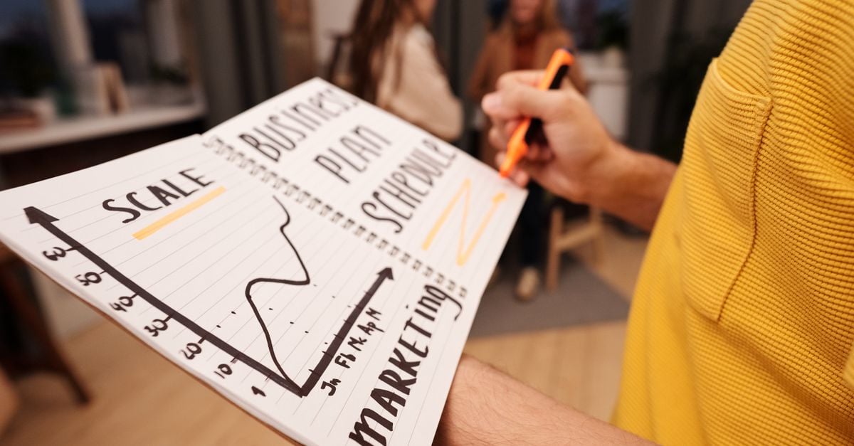 Close-up of a business notebook with marketing plans in a casual office environment.