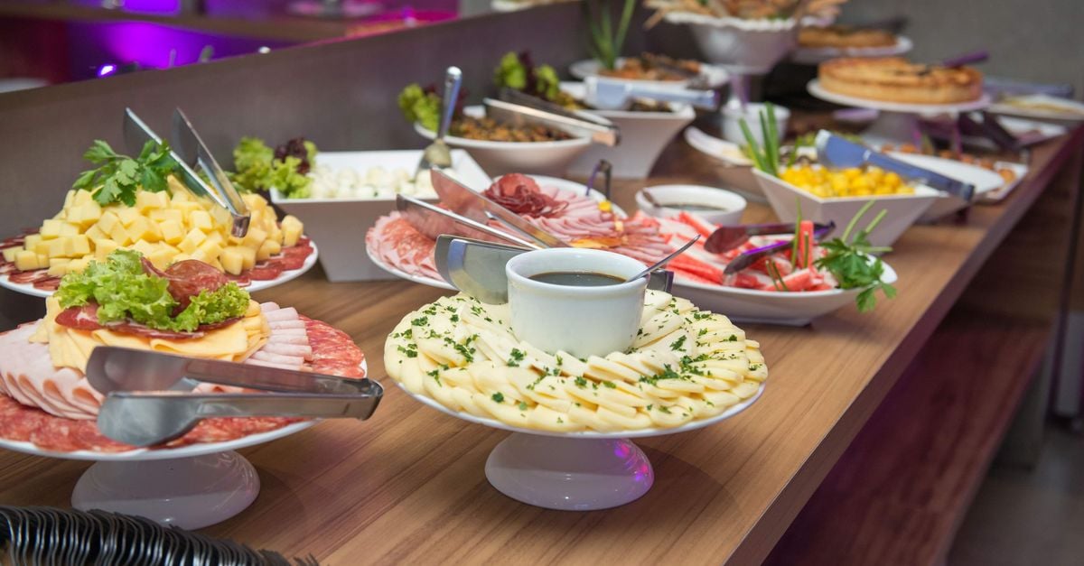 A delicious indoor buffet with assorted dishes on a wooden table.