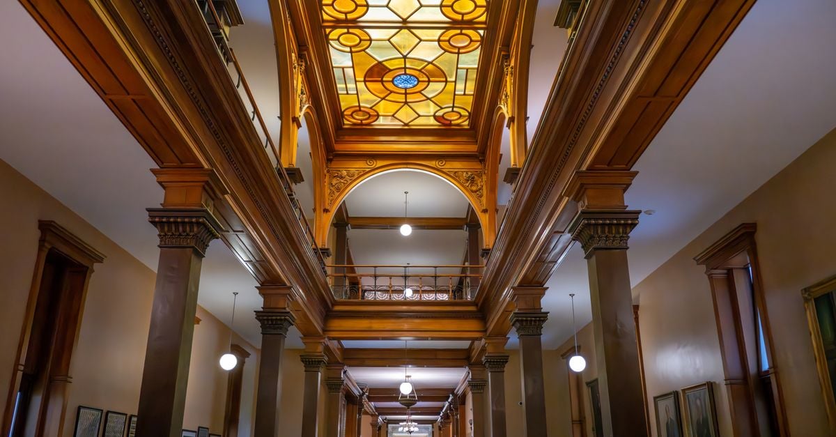 A stunning view of a historical building's interior featuring intricate stained glass and architectural details.