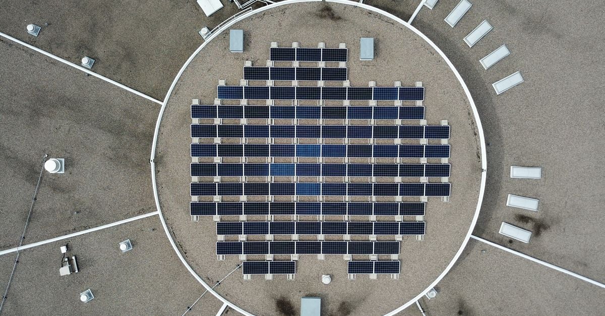 Aerial photo of a solar panel grid on a rooftop, maximizing renewable energy.