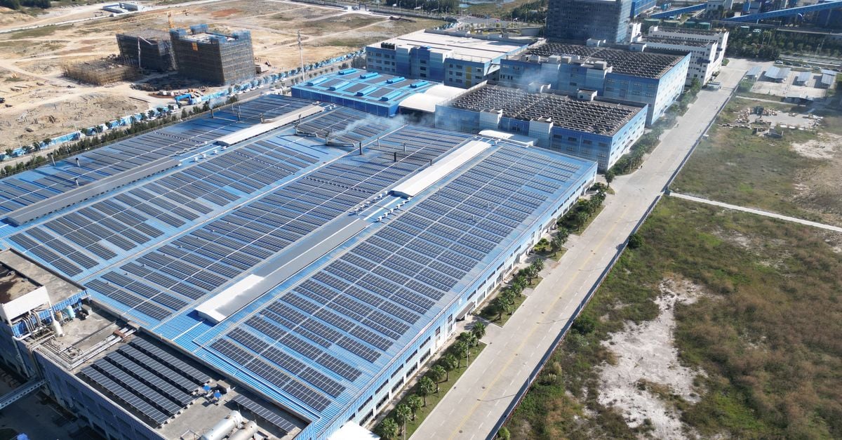 Aerial photograph showcasing large solar panels installed on an industrial building complex.